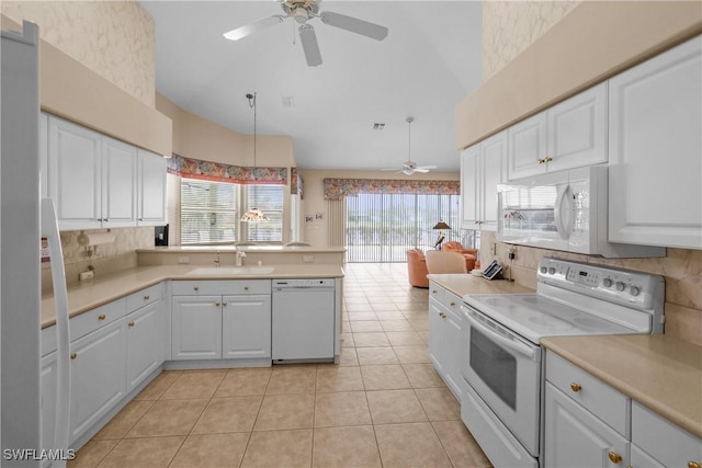 kitchen featuring white appliances, sink, light tile patterned floors, white cabinetry, and hanging light fixtures