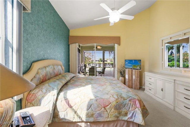 carpeted bedroom featuring ceiling fan, lofted ceiling, access to outside, and multiple windows