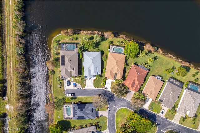 birds eye view of property with a water view