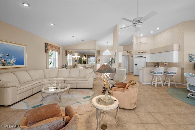 tiled living room featuring ceiling fan with notable chandelier and lofted ceiling