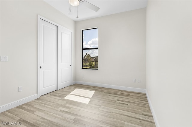 unfurnished bedroom featuring a closet, ceiling fan, and light hardwood / wood-style flooring