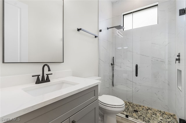 bathroom featuring vanity, toilet, hardwood / wood-style flooring, and an enclosed shower