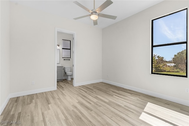 unfurnished bedroom with light hardwood / wood-style floors, connected bathroom, and ceiling fan