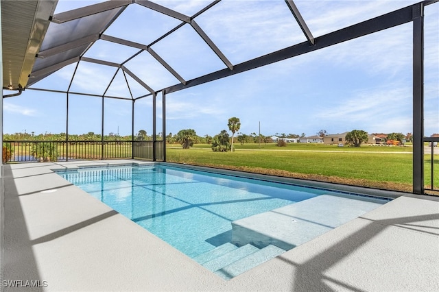 view of pool with a patio, a yard, and glass enclosure