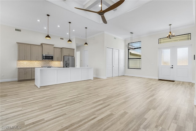 kitchen with stainless steel appliances, gray cabinets, light wood-type flooring, and hanging light fixtures