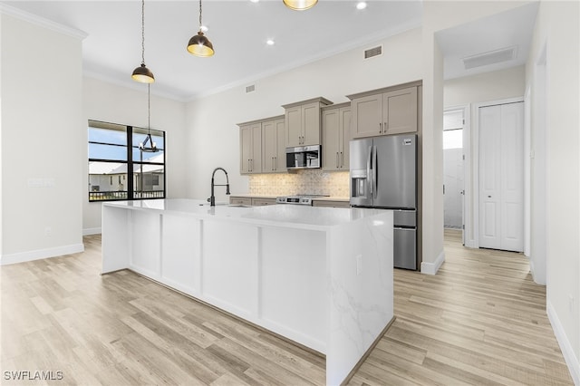 kitchen with light hardwood / wood-style floors, stainless steel appliances, sink, and crown molding