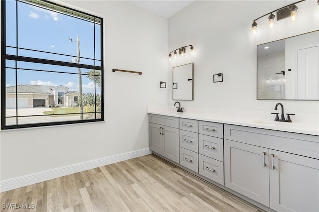 bathroom featuring vanity, a shower, and wood-type flooring