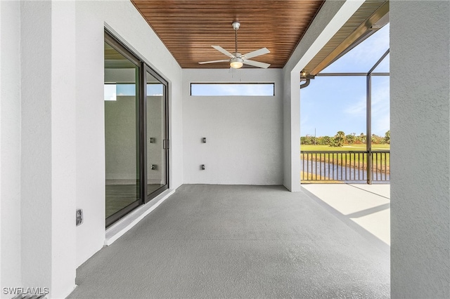 unfurnished sunroom with ceiling fan and wooden ceiling