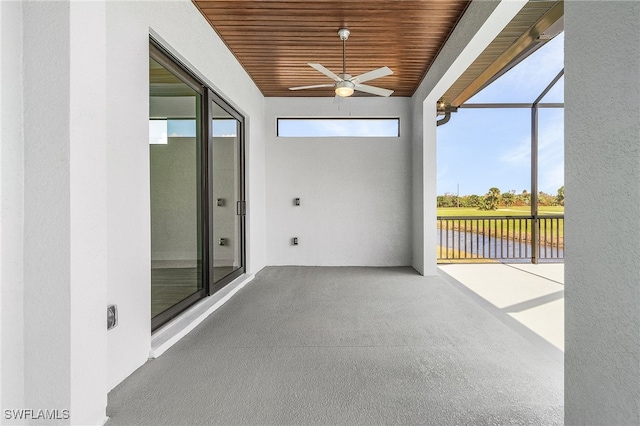 unfurnished sunroom with a wealth of natural light, wood ceiling, and ceiling fan