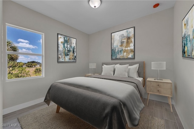 bedroom with wood-type flooring