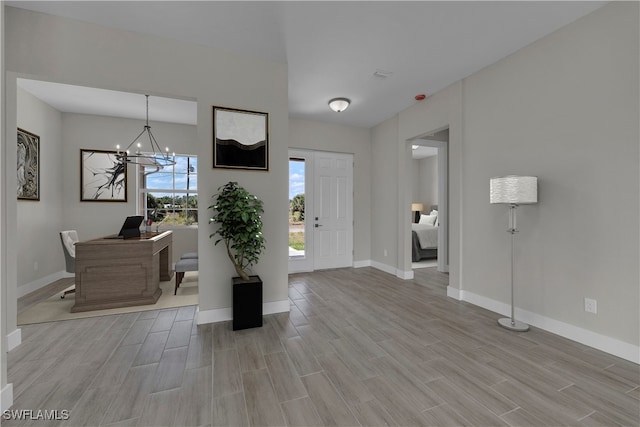 entryway with a chandelier and light wood-type flooring