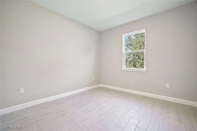 empty room with light hardwood / wood-style flooring