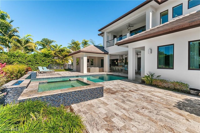 view of swimming pool featuring an in ground hot tub, a patio area, and ceiling fan