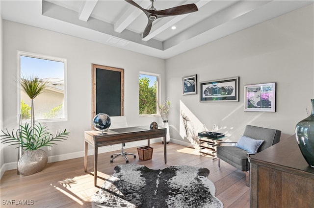 office space with ceiling fan, beam ceiling, and light hardwood / wood-style flooring