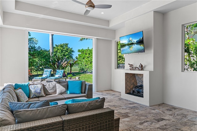 living room with ceiling fan and plenty of natural light