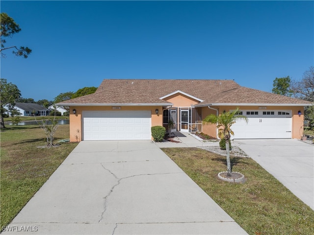 ranch-style house featuring a front yard and a garage