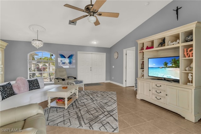 tiled living room featuring ceiling fan and vaulted ceiling