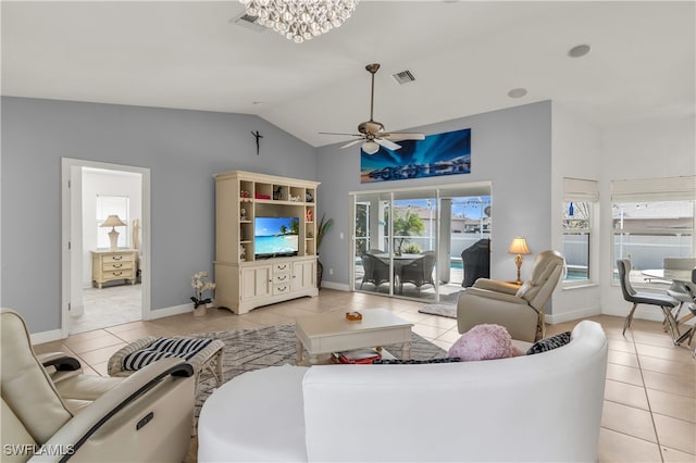 living room with ceiling fan with notable chandelier, light tile patterned floors, and vaulted ceiling