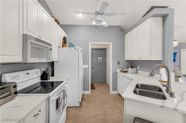 kitchen featuring white appliances, sink, ceiling fan, light tile patterned flooring, and white cabinetry