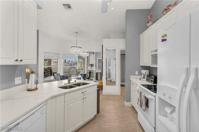 kitchen featuring white appliances, white cabinetry, hanging light fixtures, and sink