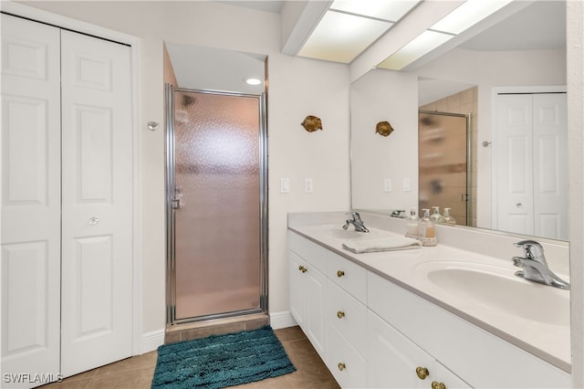 bathroom featuring tile patterned floors, vanity, and a shower with shower door