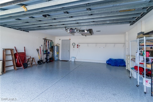 garage featuring electric water heater and a garage door opener