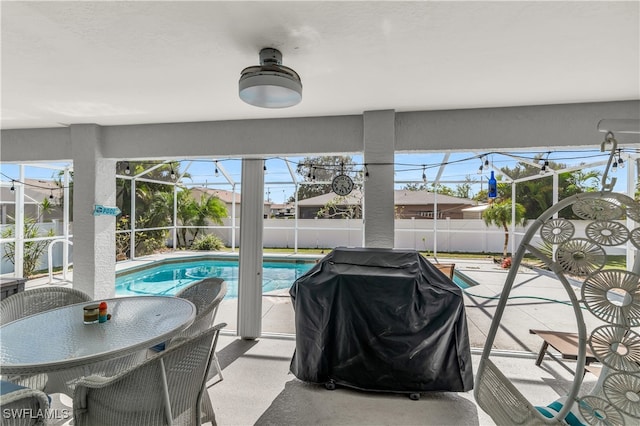 view of swimming pool with a lanai, grilling area, and a patio