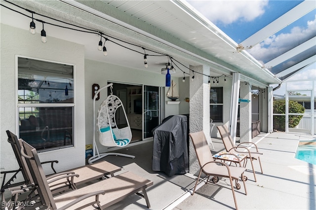 view of patio / terrace featuring glass enclosure