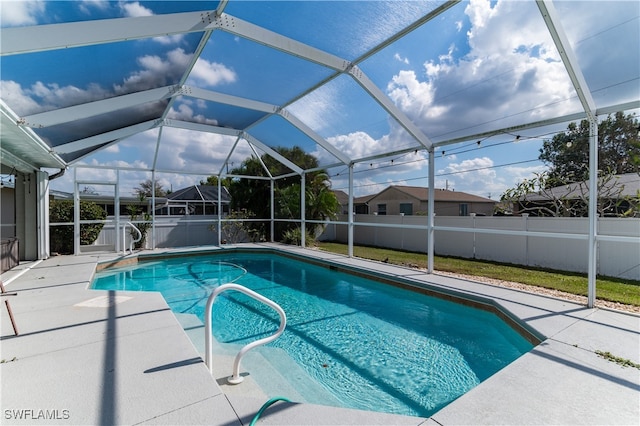 view of swimming pool with a lanai and a patio