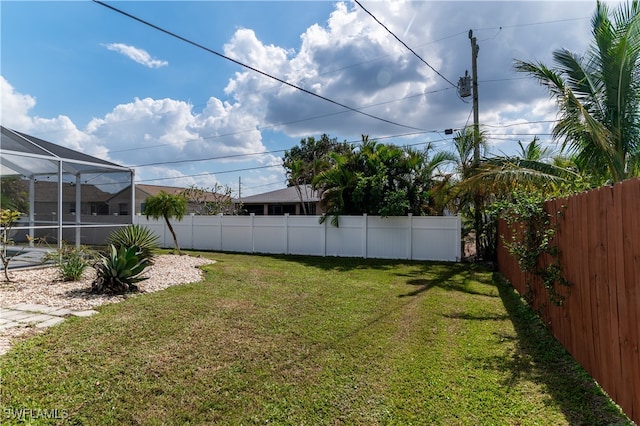 view of yard featuring glass enclosure