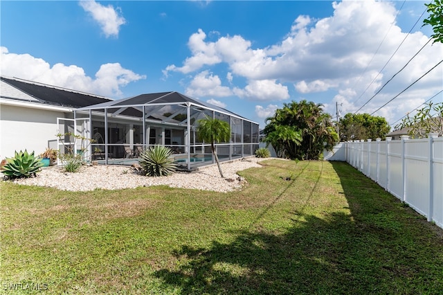 view of yard featuring a fenced in pool and a lanai