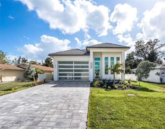 view of front of home featuring a garage and a front lawn