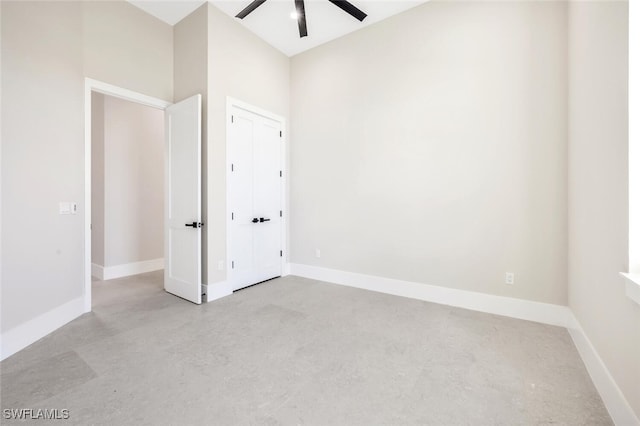 spare room featuring ceiling fan and a high ceiling