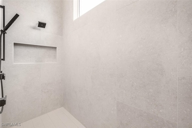 bathroom with a tile shower