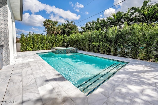 view of swimming pool with an in ground hot tub and a patio area