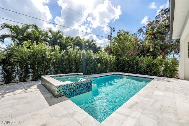 view of swimming pool with an in ground hot tub and a patio area