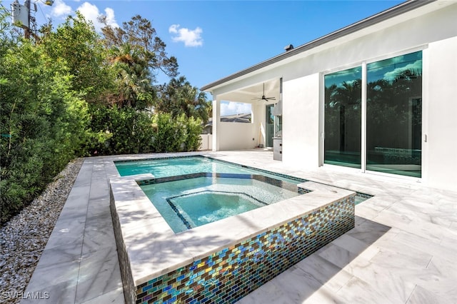 view of pool featuring an in ground hot tub, ceiling fan, and a patio area