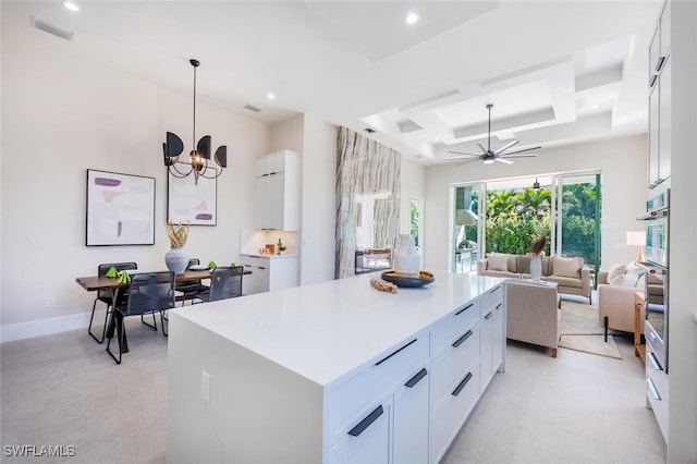 kitchen with hanging light fixtures, a center island, and white cabinets