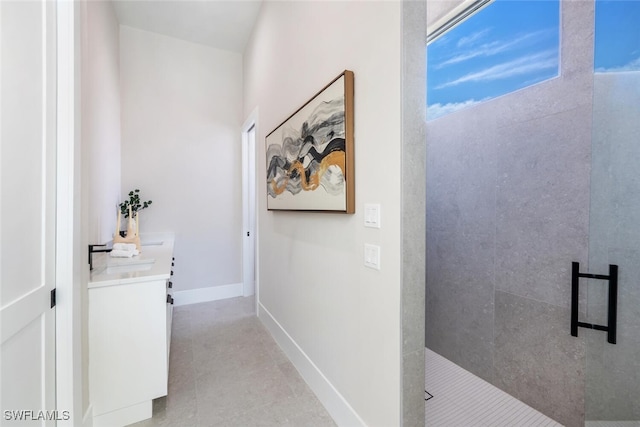 hall with sink and light tile patterned floors