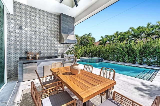 view of swimming pool with an in ground hot tub, a grill, sink, and a patio area