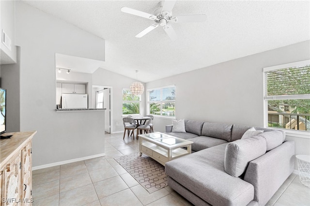 living room featuring a textured ceiling, light tile patterned floors, ceiling fan with notable chandelier, and vaulted ceiling