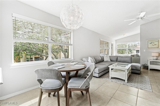 tiled dining room featuring lofted ceiling and ceiling fan with notable chandelier