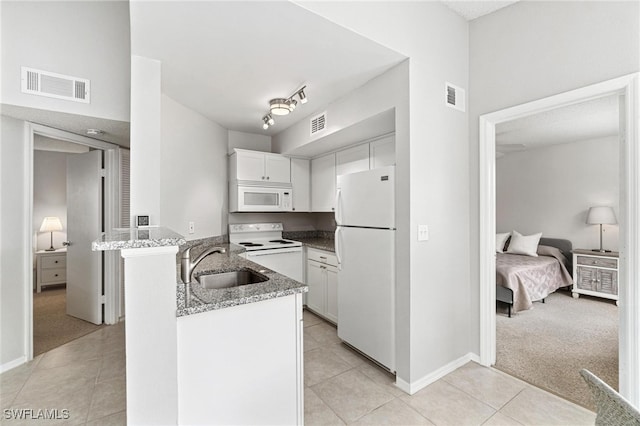 kitchen featuring kitchen peninsula, white cabinets, sink, and white appliances