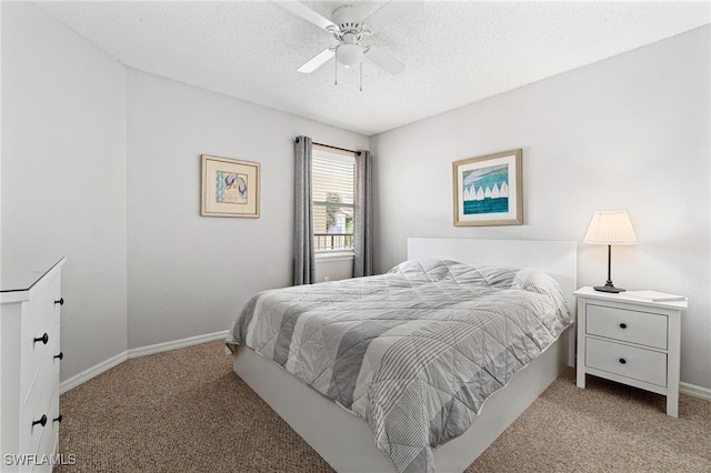 bedroom with ceiling fan, light carpet, and a textured ceiling