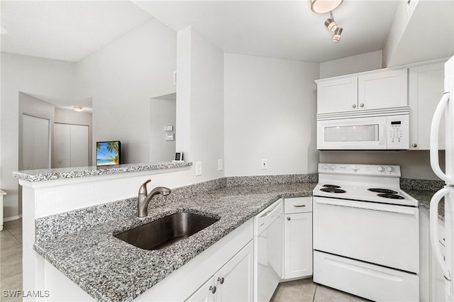 kitchen featuring white appliances, sink, kitchen peninsula, and white cabinets