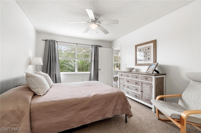 bedroom featuring a textured ceiling, carpet, and ceiling fan