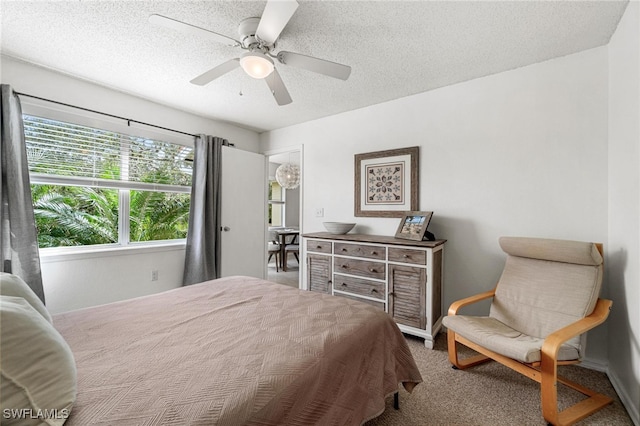 carpeted bedroom with a textured ceiling and ceiling fan