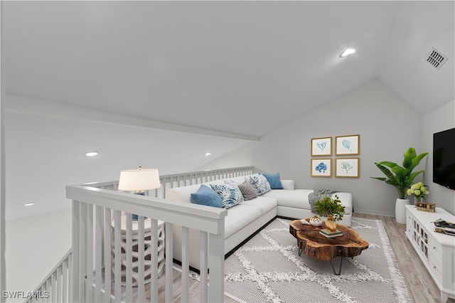 living room with light hardwood / wood-style flooring and lofted ceiling