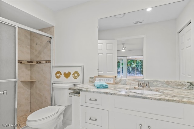 bathroom featuring walk in shower, ceiling fan, vanity, and toilet