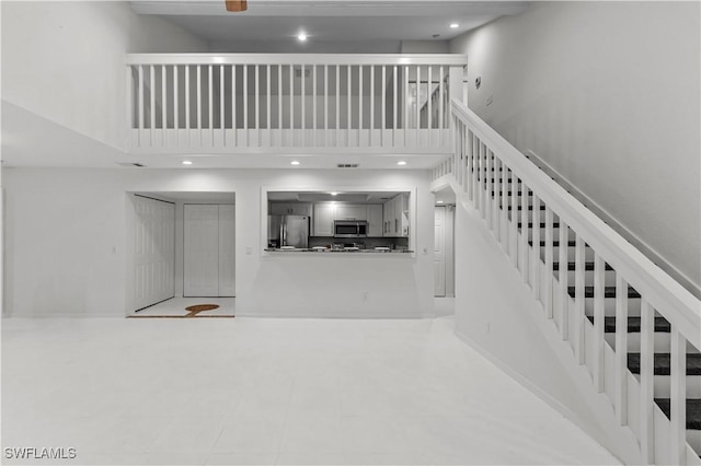 3352 Timberwood Cir, Naples, FL 34105 - stairway with a high ceiling and recessed lighting